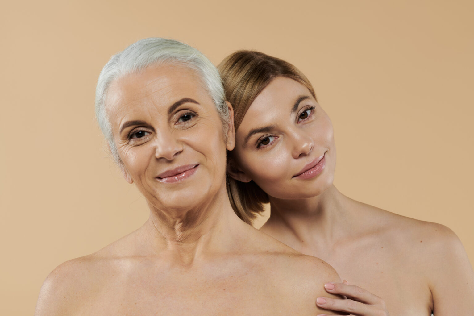 A joyful moment shared by a mature woman and her adult daughter.